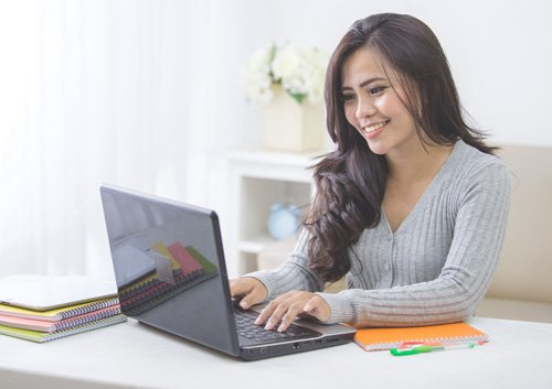 woman studying and using her laptop