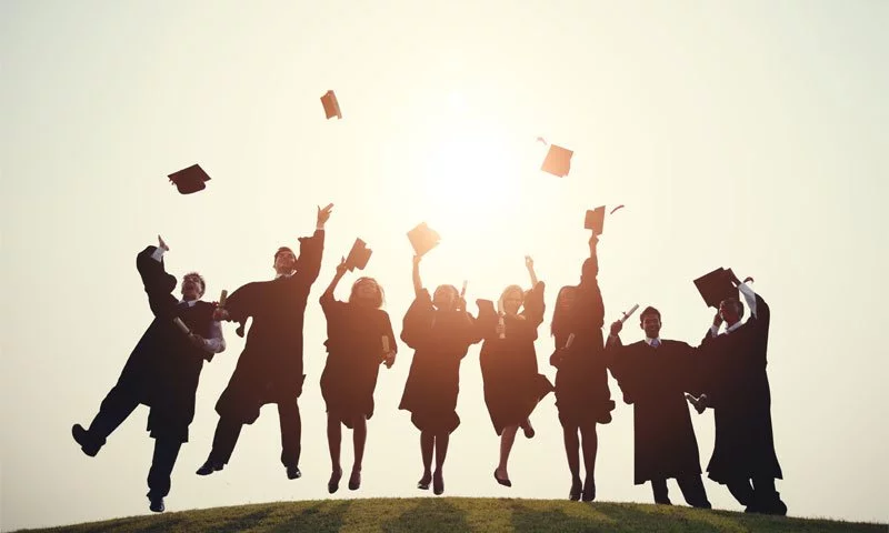 jumpshot of graduates