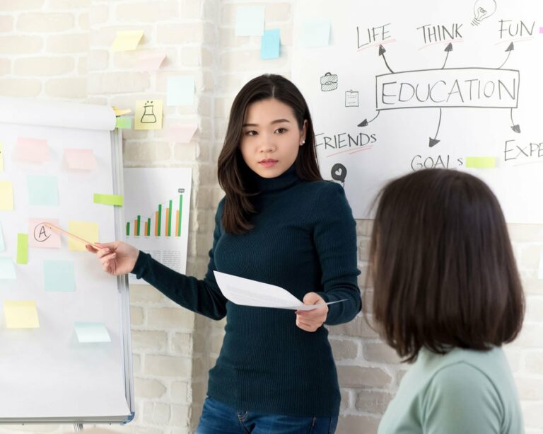 asian woman teaching another woman