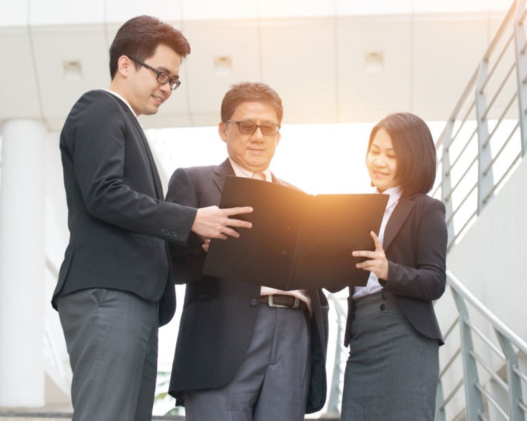 three people talking about a business proposal