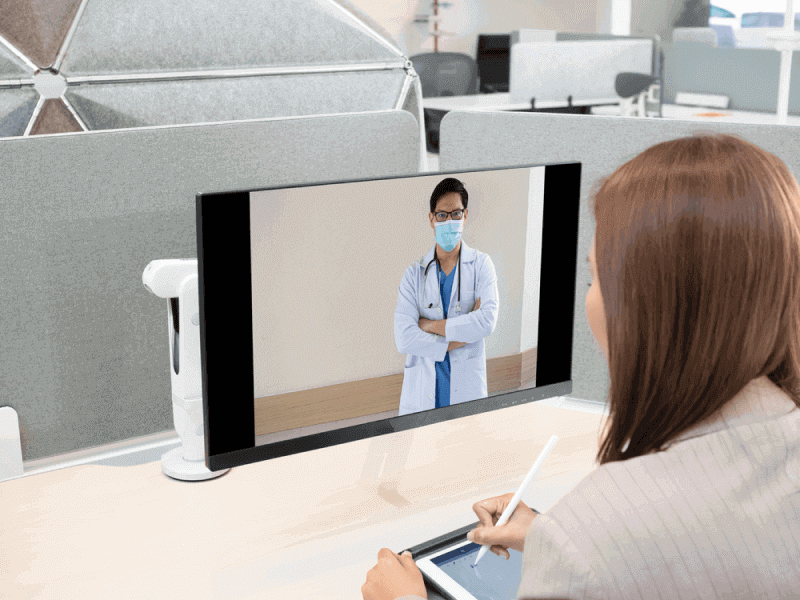 female watching a doctor in her computer