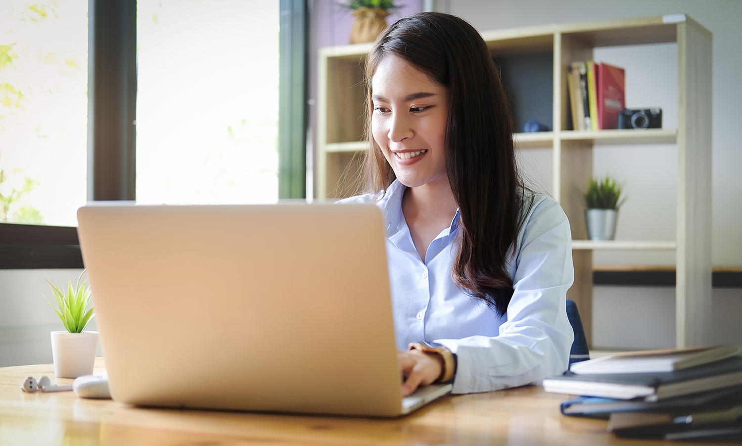 woman typing on her laptop