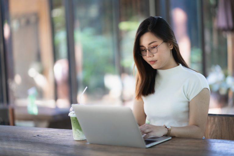 freelance IT professional doing her work in a coffee shop