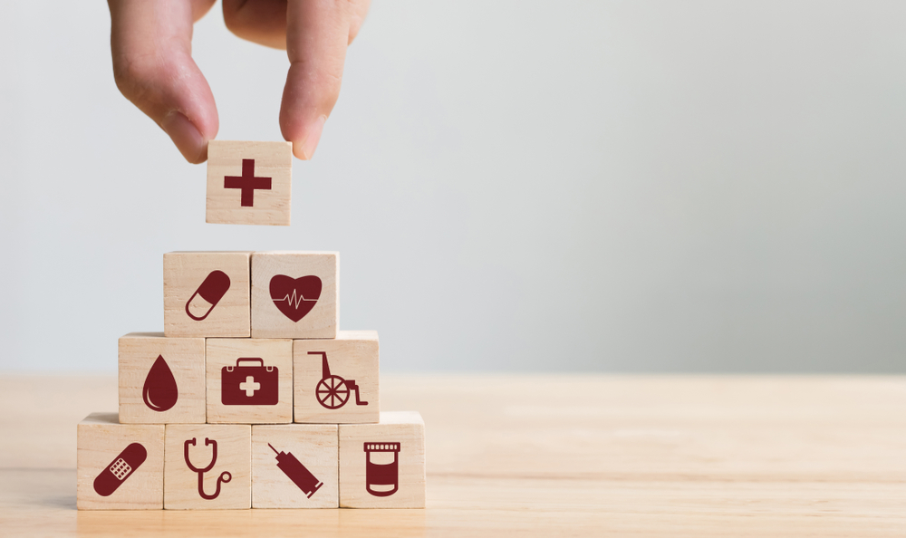 wooden blocks showing different healthcare tools