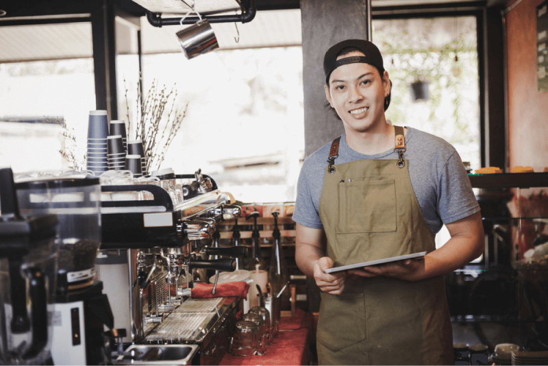 young asian man working at a coffee shop