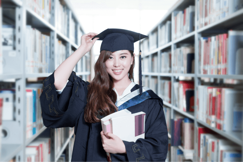 female graduate at a library