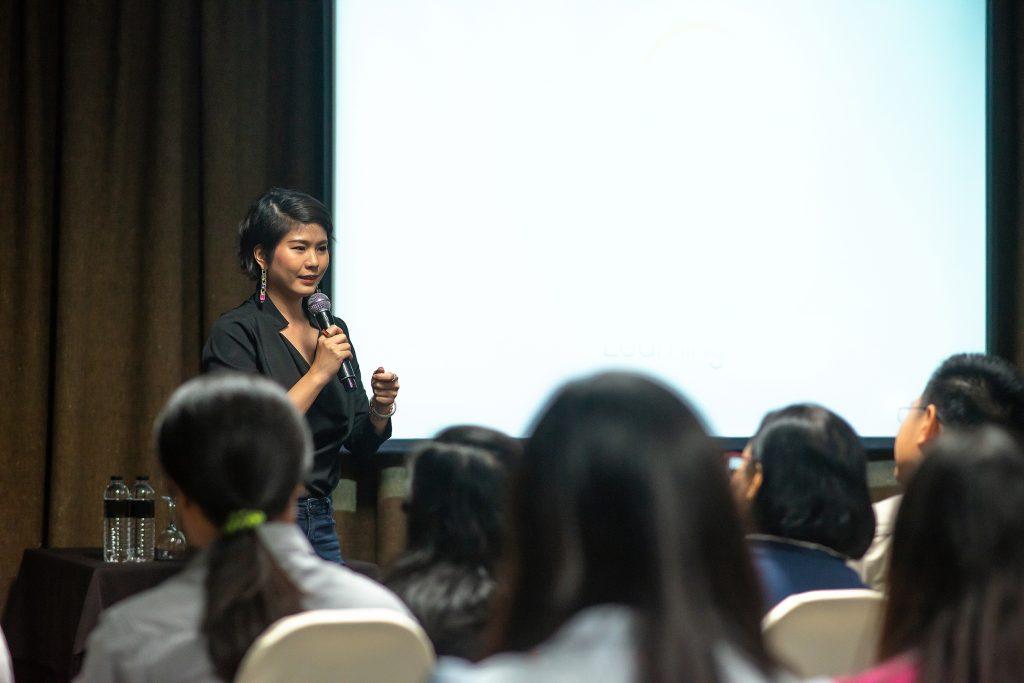 a woman speaking in front of public relations and public affairs students