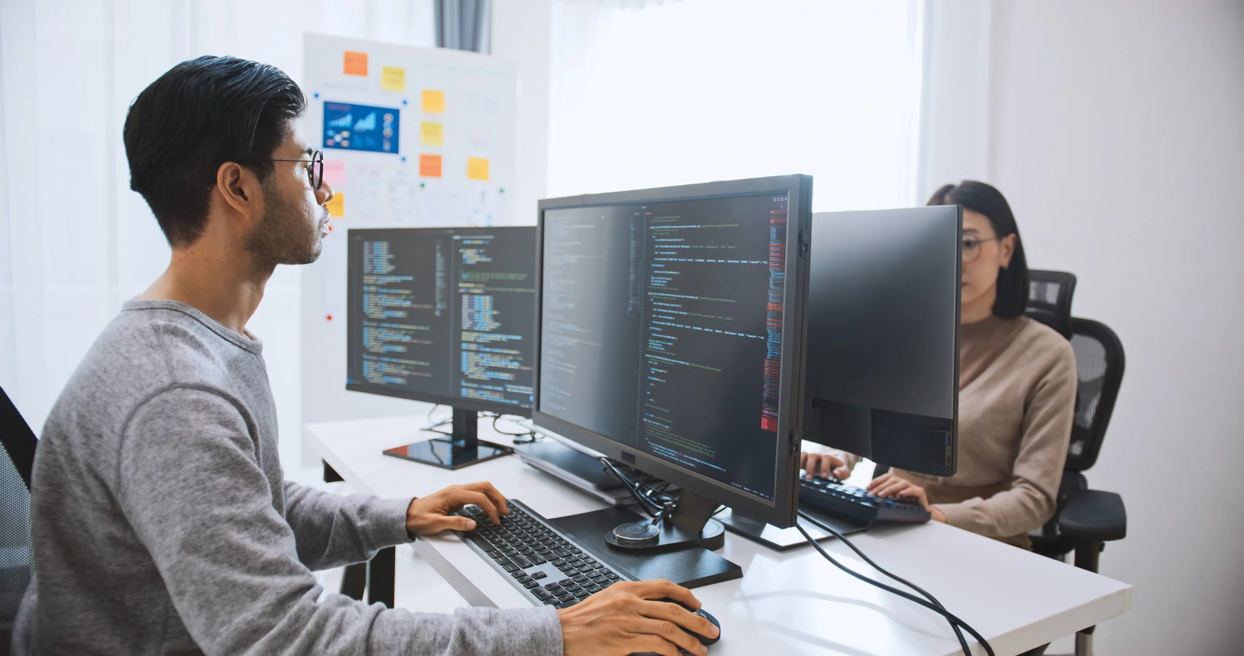 two computer science students using computers