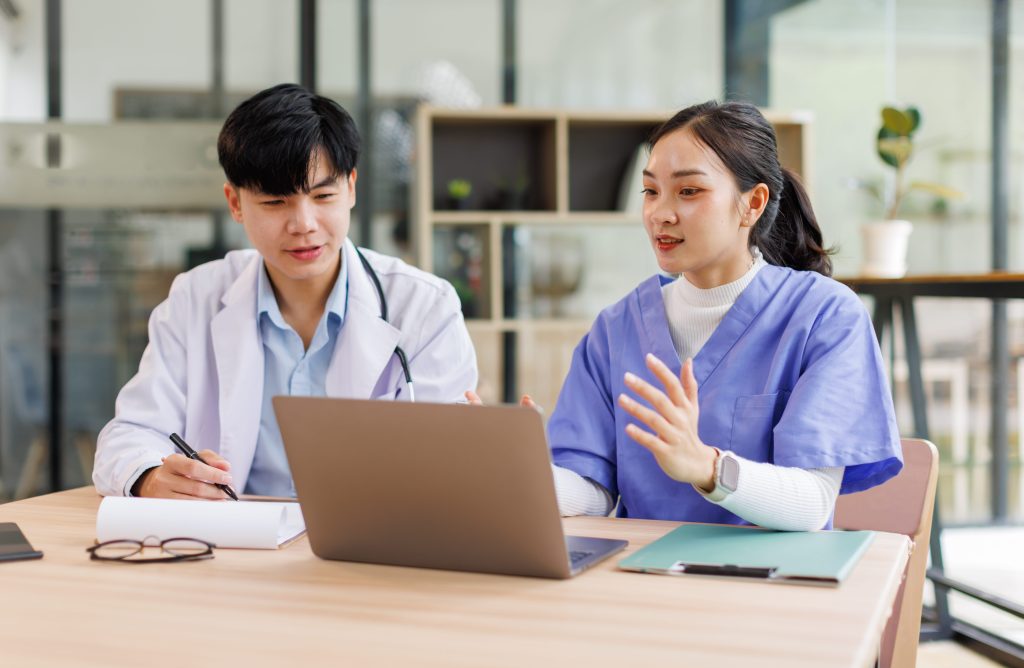 two professional healthcare workers discussing a case