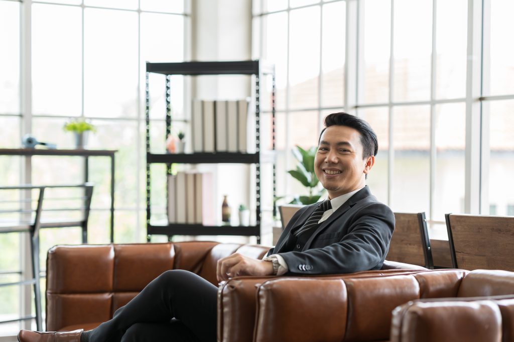 an executive sitting on a sofa