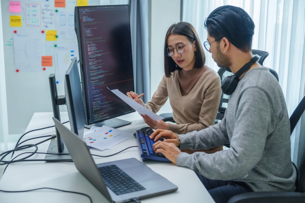 two AI developers discussing work