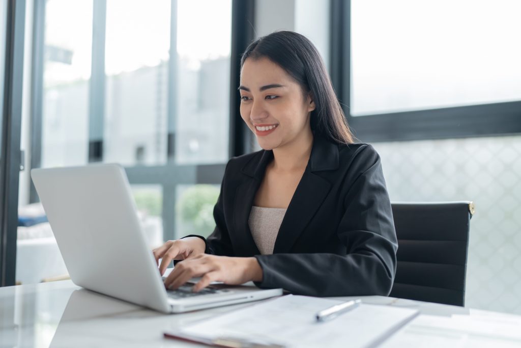 a doctoral in business administration typing on her laptop